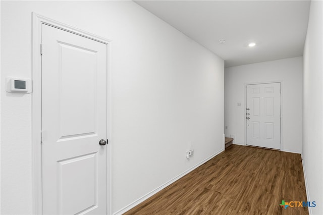 hallway with dark hardwood / wood-style floors