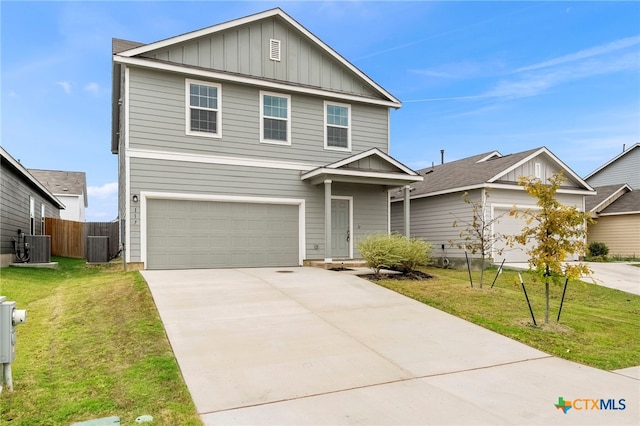 view of front of property featuring a garage, cooling unit, and a front lawn