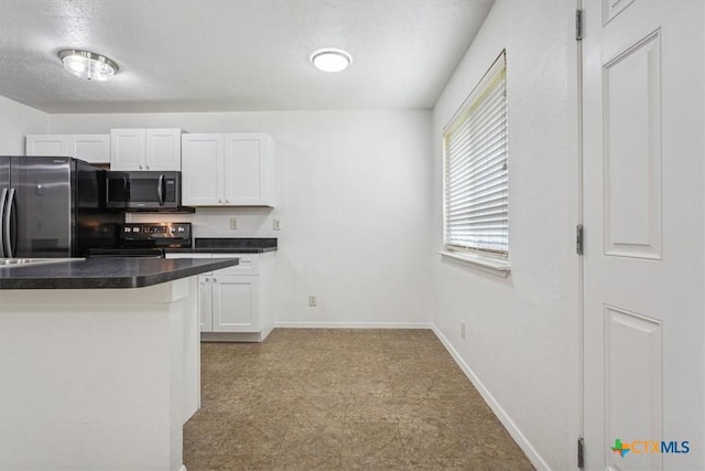 kitchen with appliances with stainless steel finishes, dark countertops, white cabinets, baseboards, and light floors