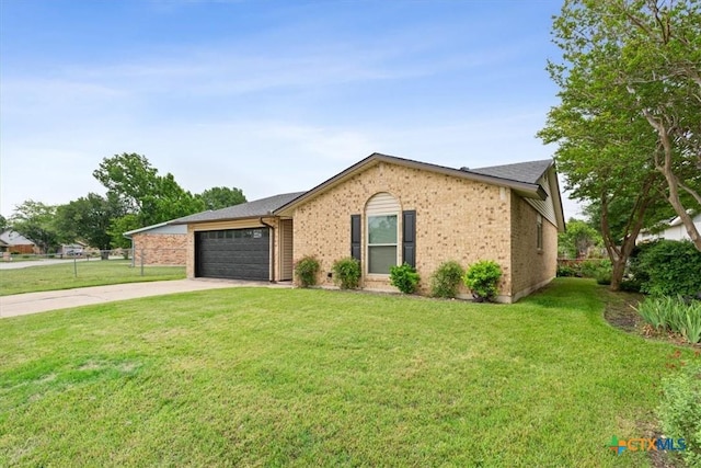 view of front of home featuring an attached garage, concrete driveway, and brick siding