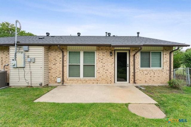 back of house featuring a patio area, brick siding, and cooling unit