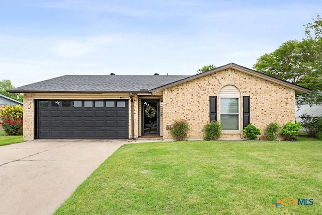4801 Calle Nogal St, Temple, TX 76502 - view of front of house featuring brick siding, an attached garage, concrete driveway, a front yard, and roof with shingles