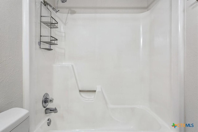 full bathroom with toilet and bathing tub / shower combination