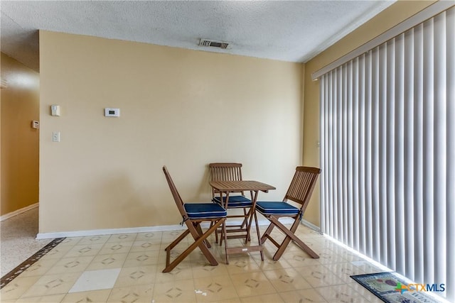 dining room with a textured ceiling