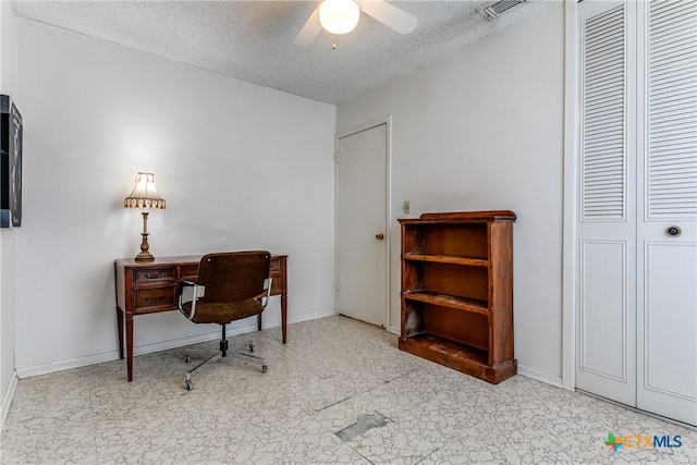 office area featuring ceiling fan and a textured ceiling