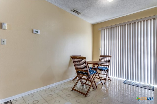 dining room with a textured ceiling