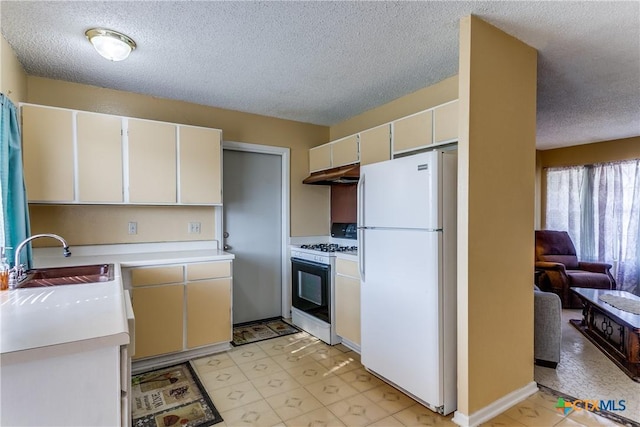 kitchen featuring white appliances, sink, a textured ceiling, and white cabinets