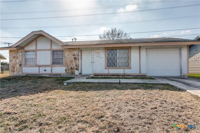 view of front of property with a garage and a front lawn