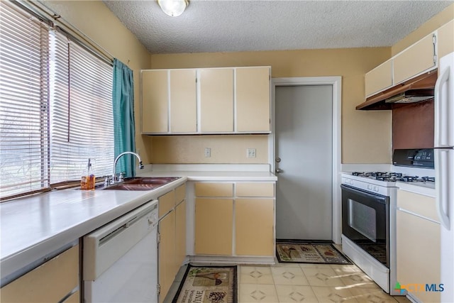 kitchen with sink, white appliances, and a textured ceiling