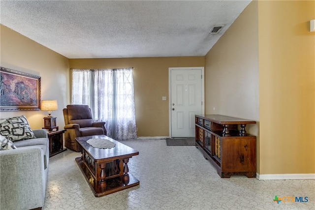 living room featuring light carpet and a textured ceiling