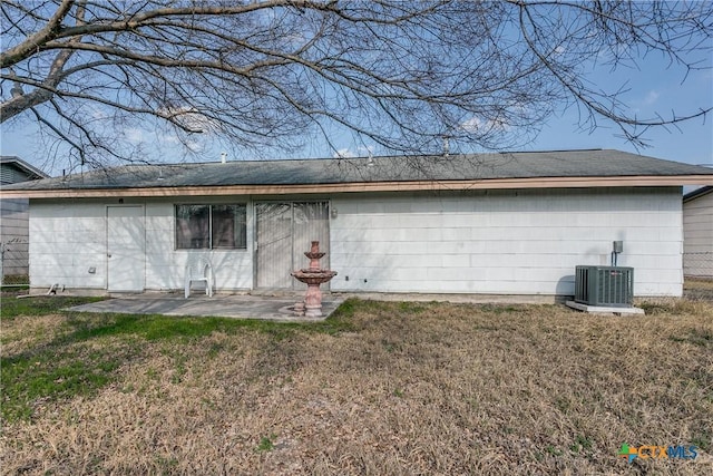 back of house featuring a patio, a lawn, and central air condition unit