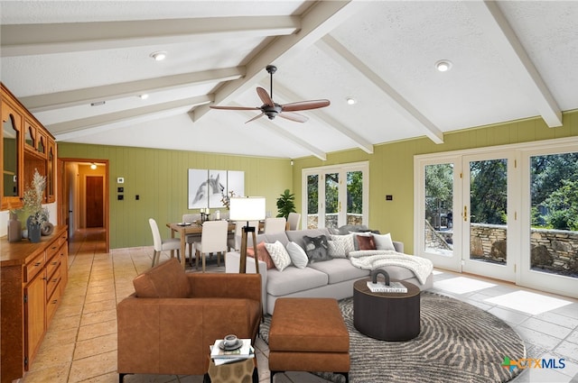 living room featuring lofted ceiling with beams, a ceiling fan, and a textured ceiling