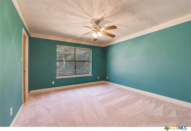 carpeted empty room with a textured ceiling, ceiling fan, and crown molding