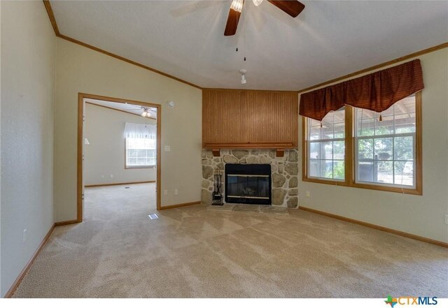 living room featuring a fireplace, a wealth of natural light, wooden walls, and a textured ceiling