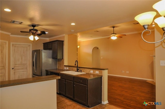 5832 Alexandria Dr, Temple, TX 76502 - kitchen with ceiling fan, a sink, a peninsula, recessed lighting, and ornamental molding