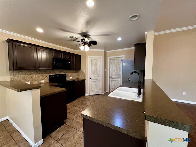 5832 Alexandria Dr, Temple, TX 76502 - kitchen featuring black appliances, a sink, a peninsula, dark brown cabinets, and dark countertops