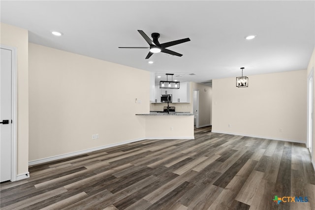 5224 Rose Garden Loop, Killeen, TX 76542 - unfurnished living room featuring dark wood finished floors, recessed lighting, ceiling fan, baseboards, and a chandelier