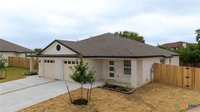 5224 Rose Garden Loop, Killeen, TX 76542 - view of front of house with a gate, a garage, concrete driveway, and brick siding