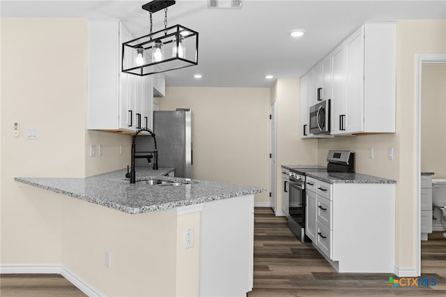 5224 Rose Garden Loop, Killeen, TX 76542 - kitchen with stainless steel appliances, dark wood-type flooring, a peninsula, white cabinets, and light stone countertops