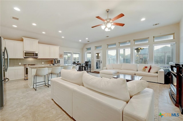 living room with light tile patterned flooring and ceiling fan