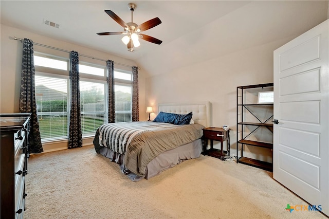 carpeted bedroom featuring ceiling fan and vaulted ceiling