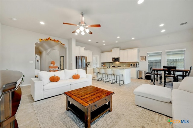 living room featuring ceiling fan and sink