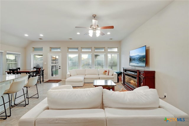 living room with ceiling fan and vaulted ceiling