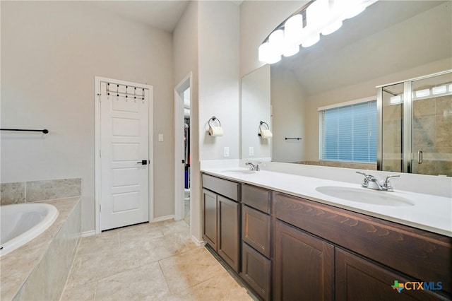 bathroom featuring plus walk in shower, vanity, and tile patterned floors