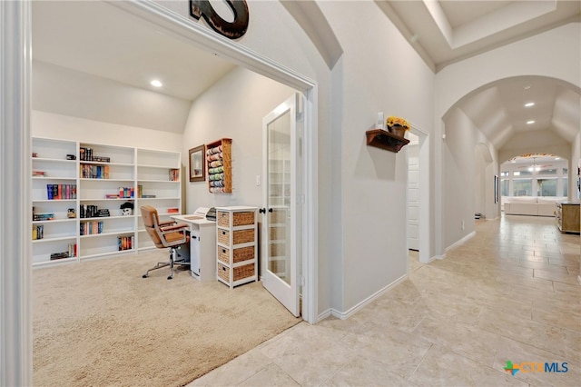 carpeted office space with arched walkways, lofted ceiling, recessed lighting, tile patterned flooring, and baseboards
