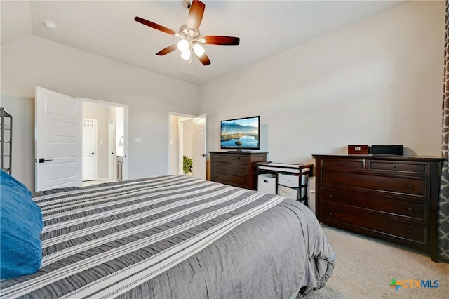 bedroom with vaulted ceiling, light carpet, and ceiling fan