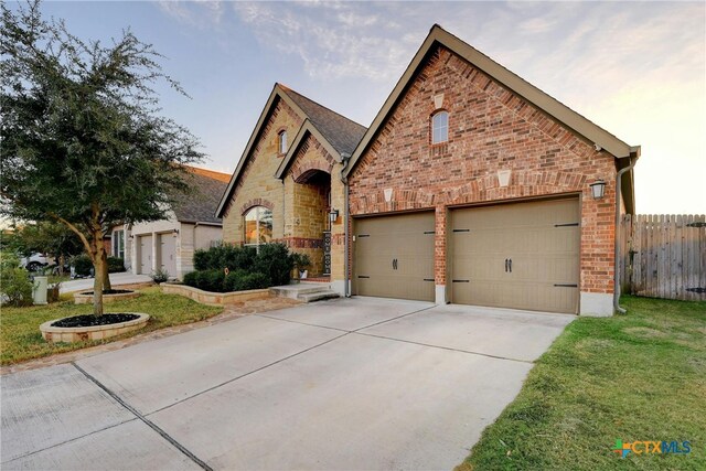 tudor-style house with a front yard and a garage