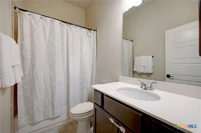 full bathroom featuring toilet, vanity, tile patterned floors, and shower / tub combo with curtain