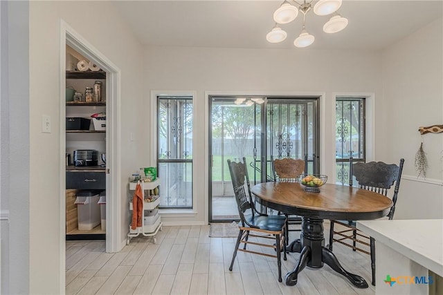 dining space featuring an inviting chandelier and light wood-style flooring