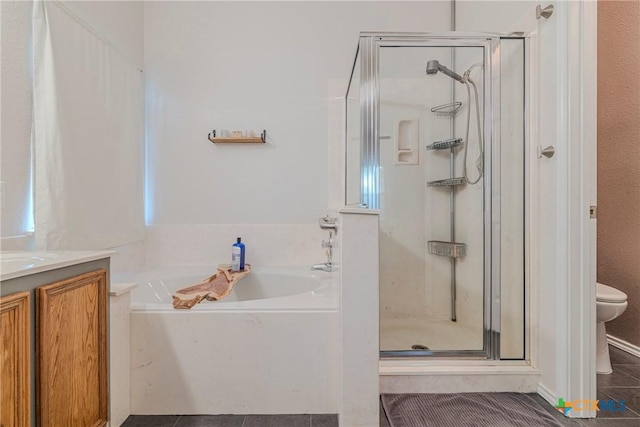bathroom featuring a garden tub, tile patterned flooring, a shower stall, vanity, and toilet