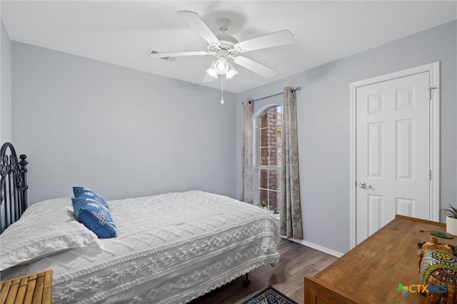 bedroom featuring a ceiling fan, wood finished floors, and baseboards