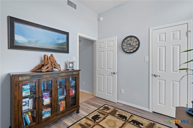 interior space with visible vents, baseboards, and light wood-style floors