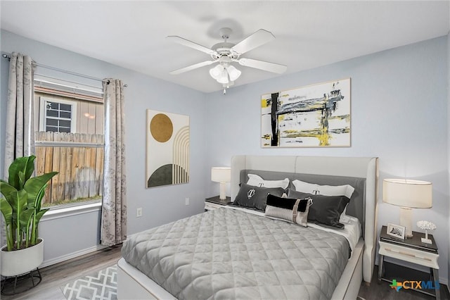 bedroom with a ceiling fan and wood finished floors