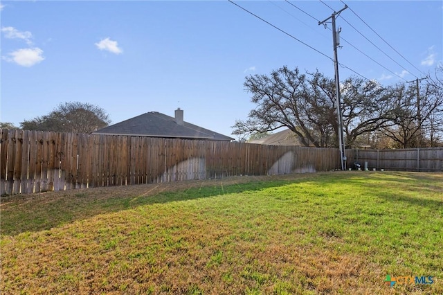 view of yard with a fenced backyard