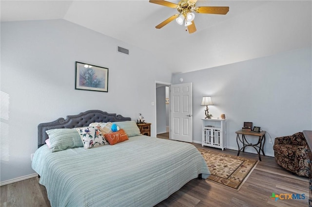 bedroom featuring lofted ceiling, wood finished floors, baseboards, and ceiling fan