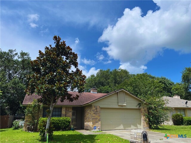 308 Fernwood Cir, Victoria, TX 77901 - ranch-style home with brick siding, a garage, concrete driveway, and a chimney