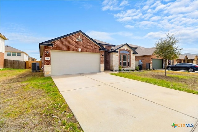 ranch-style home with driveway, central AC, fence, an attached garage, and brick siding