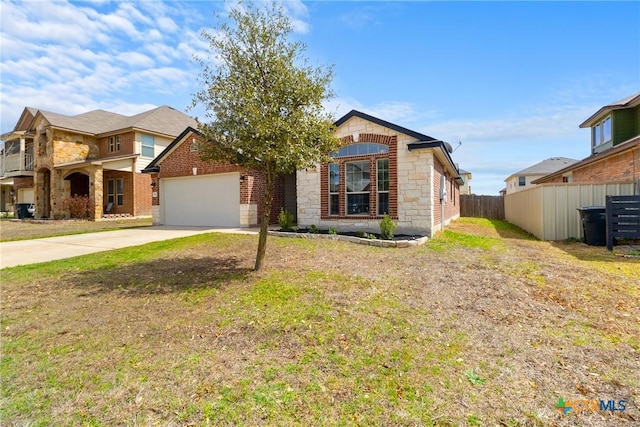 view of front of home with brick siding, fence, concrete driveway, a garage, and stone siding