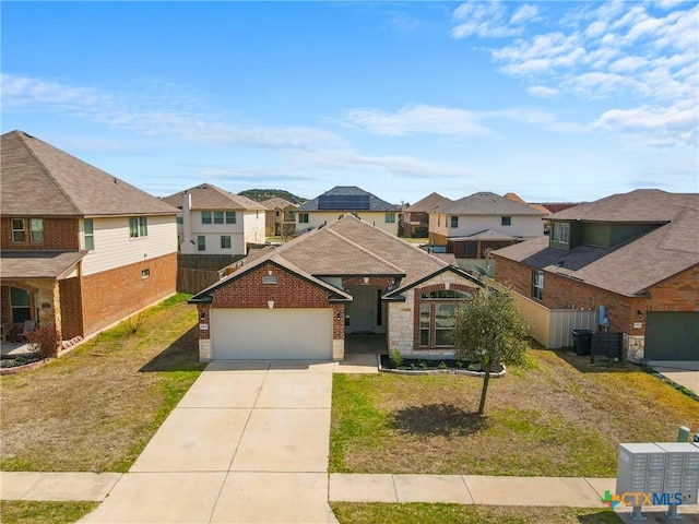 view of front of house featuring a garage, a residential view, a front yard, and driveway