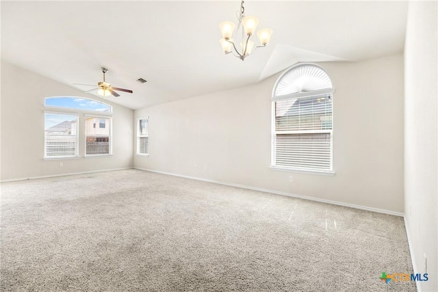 unfurnished room with visible vents, ceiling fan with notable chandelier, carpet flooring, baseboards, and vaulted ceiling