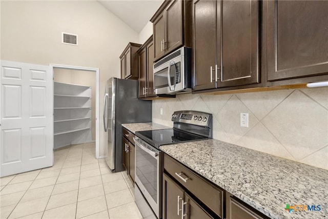 kitchen with tasteful backsplash, visible vents, dark brown cabinetry, vaulted ceiling, and appliances with stainless steel finishes