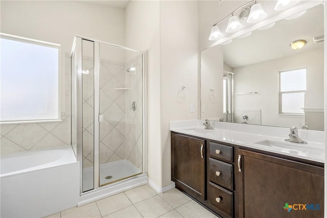 full bathroom featuring tile patterned floors, a stall shower, and a sink