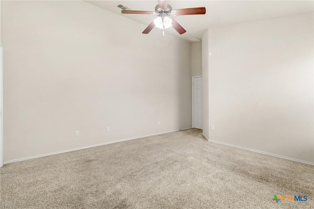 spare room featuring visible vents, light colored carpet, baseboards, and a ceiling fan