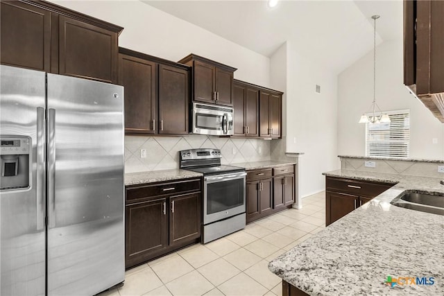 kitchen with tasteful backsplash, dark brown cabinetry, appliances with stainless steel finishes, light tile patterned flooring, and a sink