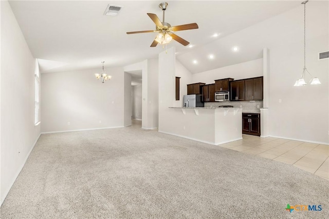 unfurnished living room featuring light carpet, visible vents, ceiling fan with notable chandelier, and light tile patterned floors