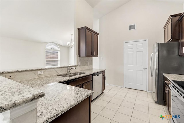 kitchen with dark brown cabinetry, visible vents, appliances with stainless steel finishes, and a sink